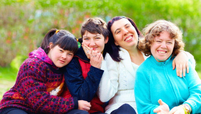 group of happy women with disability having fun in spring park