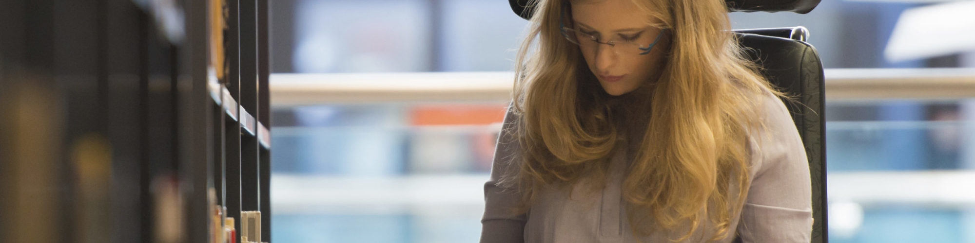 Girl In wheelchair in Library.